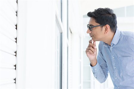 Young Asian man looking through the window and thoughtful. Stock Photo - Budget Royalty-Free & Subscription, Code: 400-08111350