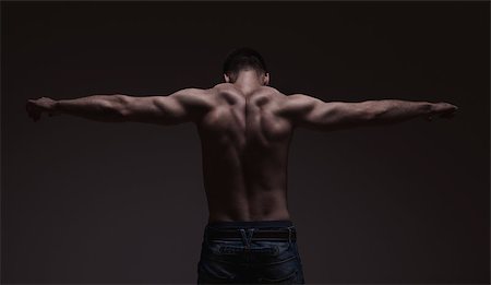 simsearch:400-07898944,k - strong athletic mans back on dark gradient grey background Stock Photo - Budget Royalty-Free & Subscription, Code: 400-08111507