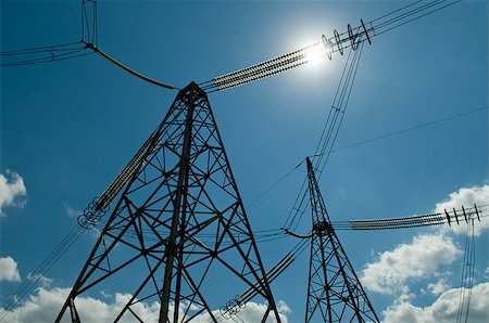 electric grid - High-voltage power line against blue sky with white clouds and sun. Idea - electricity is energy, sun also gives energy. Stock Photo - Budget Royalty-Free & Subscription, Code: 400-08111545