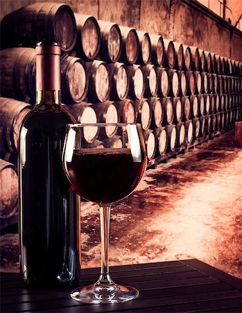 european liquor store - red wine glass near bottle in the old wine cellar with barrels background Stock Photo - Budget Royalty-Free & Subscription, Code: 400-08111741