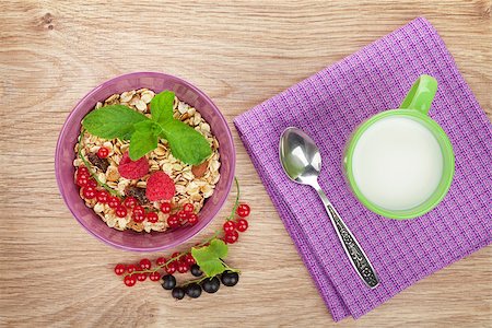 porridge and berries - Healthy breakfast with muesli and milk. View from above on wooden table Stock Photo - Budget Royalty-Free & Subscription, Code: 400-08112043