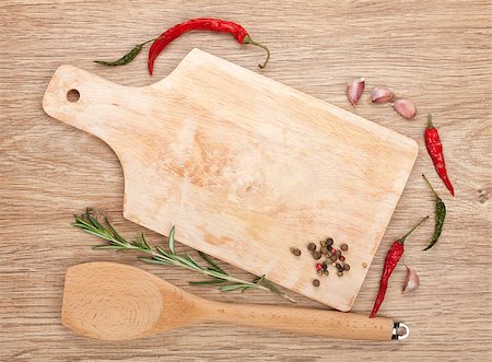 Copy space on cutting board with spices around over wooden table Stock Photo - Budget Royalty-Free & Subscription, Code: 400-08112057