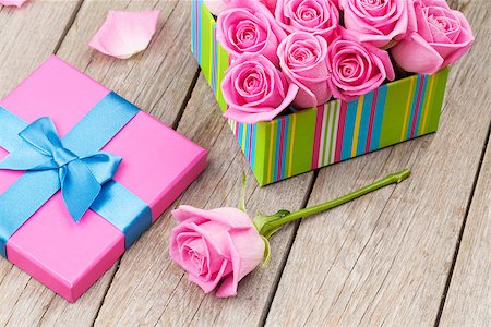 simsearch:400-08110734,k - Valentines day card with gift box full of pink roses over wooden table Stock Photo - Budget Royalty-Free & Subscription, Code: 400-08112100