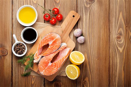 simsearch:400-08187570,k - Salmon, spices and condiments on wooden table. Top view with copy space Stockbilder - Microstock & Abonnement, Bildnummer: 400-08112457