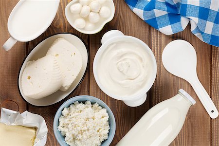 simsearch:400-07825089,k - Dairy products on wooden table. Sour cream, milk, cheese, yogurt and butter. Top view Fotografie stock - Microstock e Abbonamento, Codice: 400-08112486