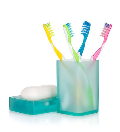 Four multicolored toothbrushes and soap. Isolated on white background Stock Photo - Budget Royalty-Free & Subscription, Code: 400-08112494
