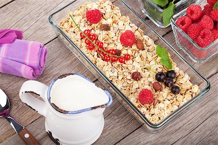 porridge and berries - Healthy breakfast with muesli, milk and berries. On wooden table Stock Photo - Budget Royalty-Free & Subscription, Code: 400-08112491
