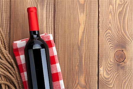 simsearch:400-07933837,k - Red wine bottle over towel on wooden table background. Top view with copy space Stockbilder - Microstock & Abonnement, Bildnummer: 400-08112506