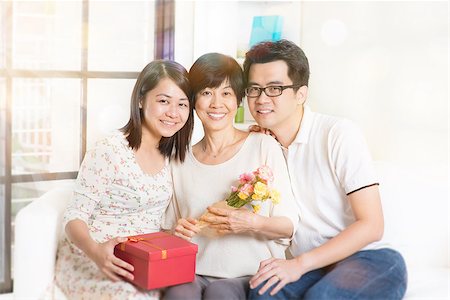 Happy mothers day. Asian senior mom received gift box and flowers from her young children. Family living lifestyle at home. Stock Photo - Budget Royalty-Free & Subscription, Code: 400-08112872