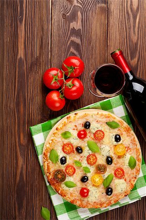 simsearch:400-05682309,k - Italian pizza with cheese, tomatoes, olives, basil and red wine on wooden table. Top view with copy space Stock Photo - Budget Royalty-Free & Subscription, Code: 400-08112904