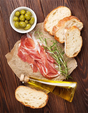simsearch:400-08291219,k - Bruschetta ingredients - prosciutto, olives and olive oil. Top view on wooden table Stock Photo - Budget Royalty-Free & Subscription, Code: 400-08112917