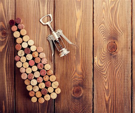 simsearch:400-07933837,k - Wine bottle shaped corks and corkscrew over rustic wooden table background. View from above with copy space Stockbilder - Microstock & Abonnement, Bildnummer: 400-08112931