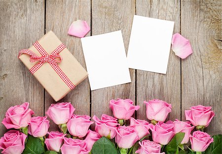simsearch:400-08110734,k - Photo frames, gift box and pink roses over wooden table. Top view Stock Photo - Budget Royalty-Free & Subscription, Code: 400-08112941