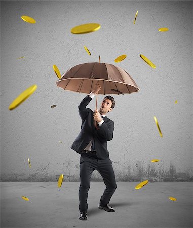 simsearch:400-07670619,k - Businessman is protected by a money rain Stock Photo - Budget Royalty-Free & Subscription, Code: 400-08113040