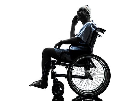 one injured man on the telephone happy in wheelchair in silhouette studio on white background Stock Photo - Budget Royalty-Free & Subscription, Code: 400-08113411