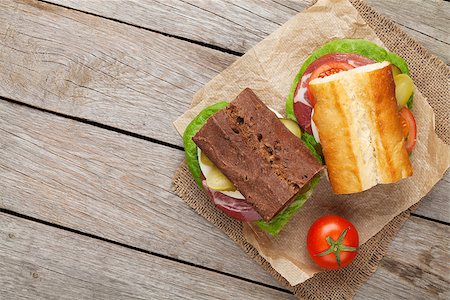 simsearch:400-07099478,k - Two sandwiches with salad, ham, cheese and tomatoes on wooden table with copy space Stock Photo - Budget Royalty-Free & Subscription, Code: 400-08113631
