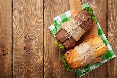 simsearch:400-07099478,k - Two sandwiches with salad, ham, cheese and tomatoes on wooden table. Top view with copy space Stock Photo - Budget Royalty-Free & Subscription, Code: 400-08113633