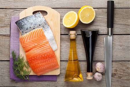 Salmon, spices and condiments on wooden table. Top view Stock Photo - Budget Royalty-Free & Subscription, Code: 400-08113641