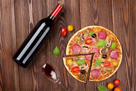 simsearch:400-08960199,k - Italian pizza with pepperoni, tomatoes, olives, basil and red wine on wooden table. Top view Stock Photo - Budget Royalty-Free & Subscription, Code: 400-08113669