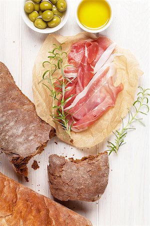 simsearch:400-08291219,k - Italian prosciutto with ciabatta and olives on white wooden table Stock Photo - Budget Royalty-Free & Subscription, Code: 400-08113693