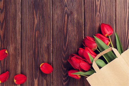 simsearch:400-08036453,k - Red tulips bouquet in paper bag over wooden table background with copy space. Toned Stock Photo - Budget Royalty-Free & Subscription, Code: 400-08113729