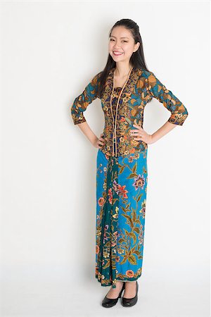 Full length Southeast Asian woman in batik dress standing on plain background. Stock Photo - Budget Royalty-Free & Subscription, Code: 400-08113767
