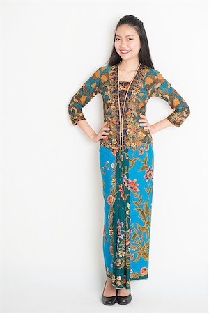 Full body Southeast Asian woman in batik dress standing on plain background. Stock Photo - Budget Royalty-Free & Subscription, Code: 400-08113804