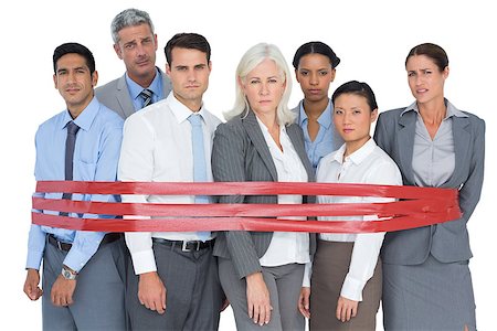 Unhappy business people surrounding by red strip in office Stock Photo - Budget Royalty-Free & Subscription, Code: 400-08135814