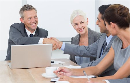 Executives shaking hands in board room meeting at office Stock Photo - Budget Royalty-Free & Subscription, Code: 400-08136018