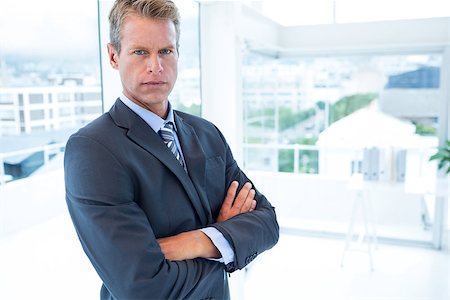 simsearch:400-07275251,k - Serious businessman looking at camera in his office Stock Photo - Budget Royalty-Free & Subscription, Code: 400-08136272