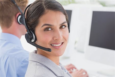 Smiling businesswoman wearing headset in call center Foto de stock - Super Valor sin royalties y Suscripción, Código: 400-08136378