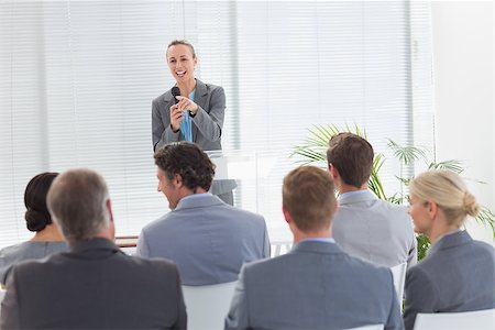 simsearch:400-08136433,k - Pretty businesswoman talking in microphone during conference in meeting room Foto de stock - Super Valor sin royalties y Suscripción, Código: 400-08136474