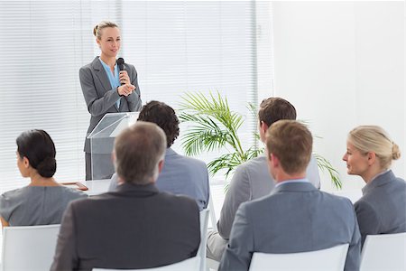 simsearch:400-08136433,k - Pretty businesswoman talking in microphone during conference in meeting room Foto de stock - Super Valor sin royalties y Suscripción, Código: 400-08136475