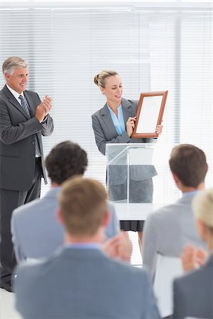 simsearch:400-08136433,k - Pretty businesswoman receiving prize in meeting room Foto de stock - Super Valor sin royalties y Suscripción, Código: 400-08136481