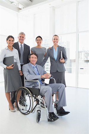 simsearch:400-08136433,k - Disabled businessman with his colleagues smiling at camera in the office Foto de stock - Super Valor sin royalties y Suscripción, Código: 400-08136530