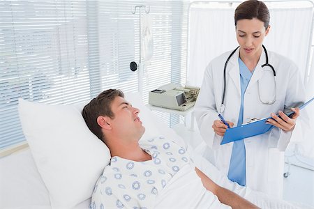 simsearch:400-06734647,k - Doctor taking care of patient in hospital room Stock Photo - Budget Royalty-Free & Subscription, Code: 400-08136694