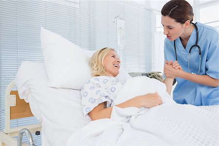 simsearch:400-06734647,k - Doctor taking care of patient in hospital room Stock Photo - Budget Royalty-Free & Subscription, Code: 400-08136696