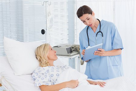 simsearch:400-06734647,k - Doctor taking care of patient in hospital room Stock Photo - Budget Royalty-Free & Subscription, Code: 400-08136697