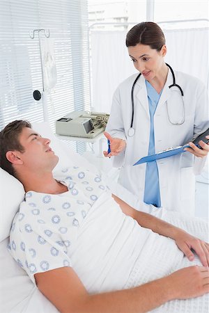 simsearch:400-06734647,k - Doctor taking care of patient in hospital room Stock Photo - Budget Royalty-Free & Subscription, Code: 400-08136693