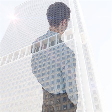 simsearch:693-03301185,k - Businessman standing with hands in pockets against skyscraper Stock Photo - Budget Royalty-Free & Subscription, Code: 400-08136892