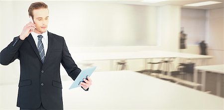 simsearch:700-02121517,k - Serious businessman on the phone holding tablet against empty class room Stock Photo - Budget Royalty-Free & Subscription, Code: 400-08137138