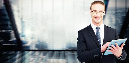 Happy businessman using his tablet pc  against window overlooking city Stock Photo - Budget Royalty-Free & Subscription, Code: 400-08137156