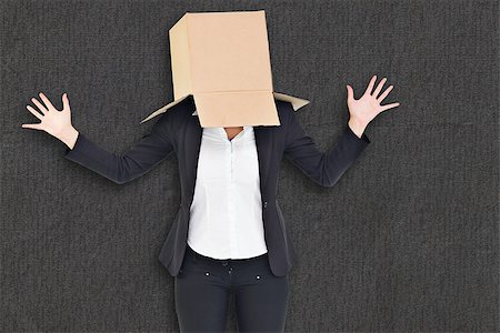 Businesswoman with box over head against grey background Stock Photo - Budget Royalty-Free & Subscription, Code: 400-08137328