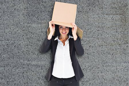 Businesswoman lifting box off head against grey background Stock Photo - Budget Royalty-Free & Subscription, Code: 400-08137330