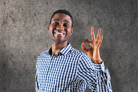 Happy businessman making ok sign against grey background Stock Photo - Budget Royalty-Free & Subscription, Code: 400-08137351