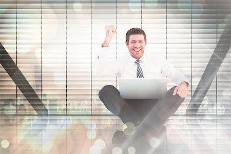 Businessman using laptop and cheering against window overlooking city Stock Photo - Budget Royalty-Free & Subscription, Code: 400-08137590
