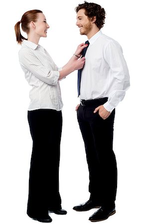 female adjust necktie - Young woman helping to knot her boyfriend's tie Stock Photo - Budget Royalty-Free & Subscription, Code: 400-08130659