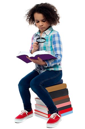 school girl holding pile of books - School girl sitting on the heap of books and reading Stock Photo - Budget Royalty-Free & Subscription, Code: 400-08130853