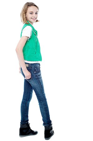 smart poses of teenager girl - Smiling young girl turning back, hands in pocket Stock Photo - Budget Royalty-Free & Subscription, Code: 400-08131210