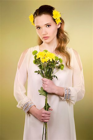 simsearch:400-07986693,k - cuacasian woman wearing yellow flowers on green background Stock Photo - Budget Royalty-Free & Subscription, Code: 400-08131694